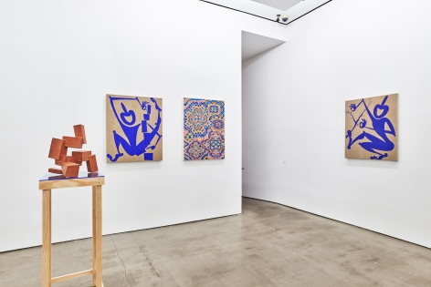 Installation view of works by Todd Kelly. Paintings and sculptures are next to each other. There is a doorway on the right