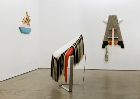 Installation view of Trish Tillman's exhibition "Stage Diver", which shows plush sculptures on the walls and standing on the floor.