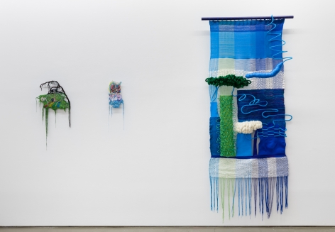 Installation view of "Adriadne Unraveling". Three textile works are hung on the wall.