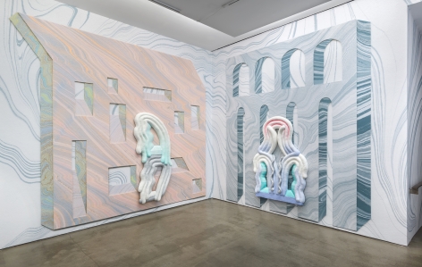 Installation view from Lauren Clay's solo exhibition. Large sculptural pieces hang on the wall. The wall is papered with custom-made wallpaper.
