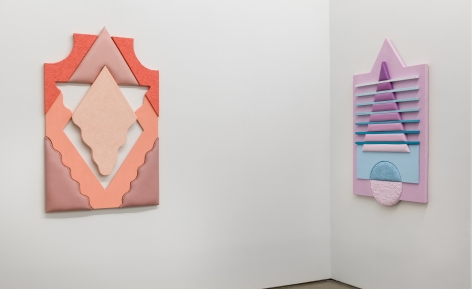 Installation views of Leah Guadagnoli's solo exhibition. Geometric sculptures made from fabric, foam, and pumice stone line the walls next to a corner.